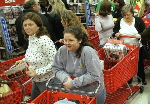 ** ADVANCE FOR FRIDAY, DEC. 22--FILE **The isle of a Tallahassee, Fla., Target store is a virtual gridlock of shopping carts as customers take advantage of early store hours looking for bargains and sales, in this  Nov. 24, 2006, file photo. There's no doubt Americans are materialistic about Christmas. Almost half of all Americans crammed stores on the day after Thanksgiving this year, the traditional beginning of the holiday shopping season. By the time the Christmas shopping season is over, the country will have spent in the neighborhood of $150 billion, most of it on gifts. That's an average of $500 for every man, woman and child in the United States.  (AP Photo/Phil Coale/FILE)